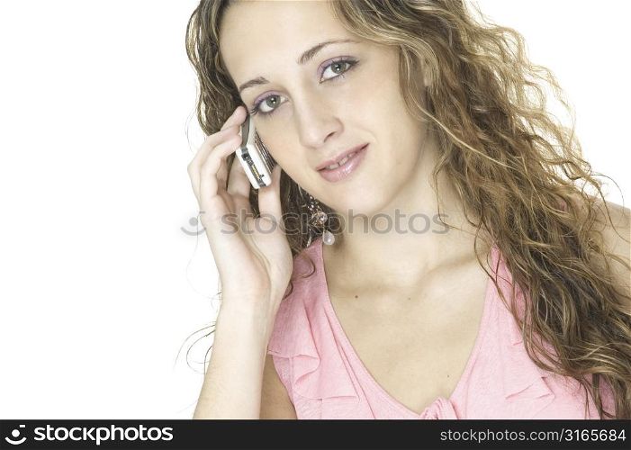 A beautiful young female talks on a cellphone