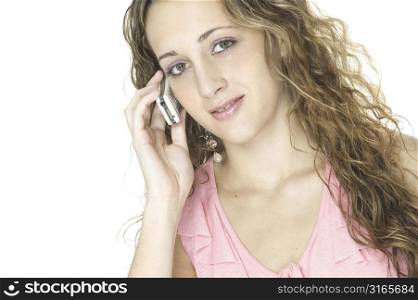 A beautiful young female talks on a cellphone