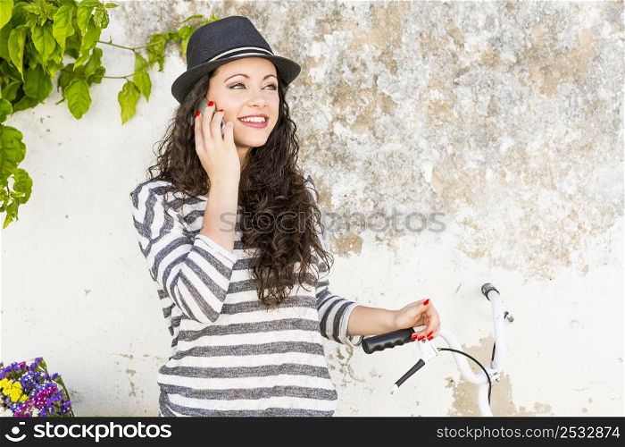 A beautiful young female tourist making a phone call
