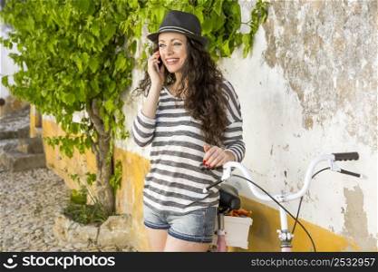 A beautiful young female tourist making a phone call