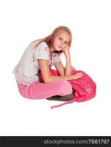 A beautiful young girl sitting sad on the floor holding her pink pack back,isolated for white background.