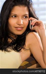 A beautiful young Hispanic woman enjoying a call on her mobile phone