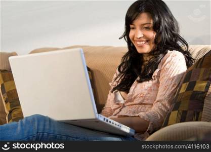 A beautiful young Hispanic woman using her laptop