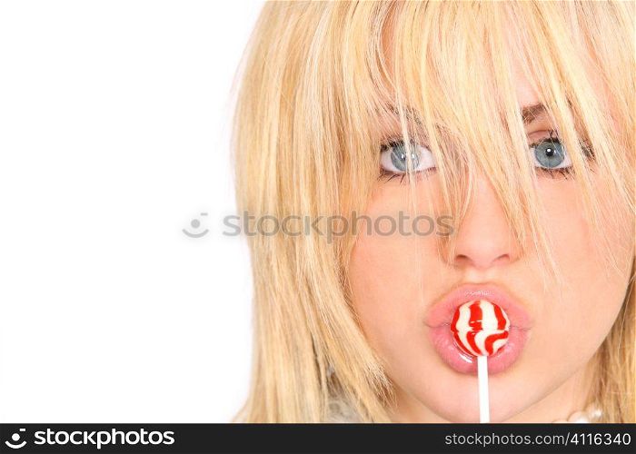 A beautiful young mdel sucking on a red and white lollipop