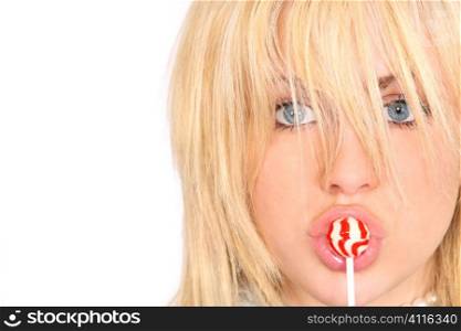 A beautiful young mdel sucking on a red and white lollipop