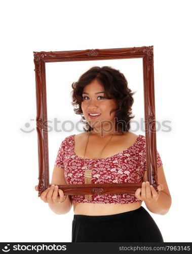 A beautiful young mixed raced woman holding an picture framein front of her, isolated for white background.