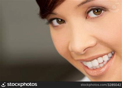 A beautiful young oriental woman with a wonderful toothy smile
