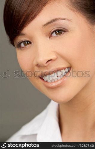 A beautiful young oriental woman with a wonderful toothy smile
