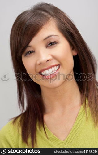 A beautiful young oriental woman with a wonderful toothy smile