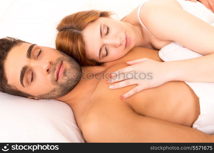 A beautiful young passionate couple in bed