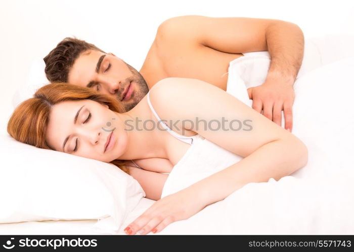 A beautiful young passionate couple in bed