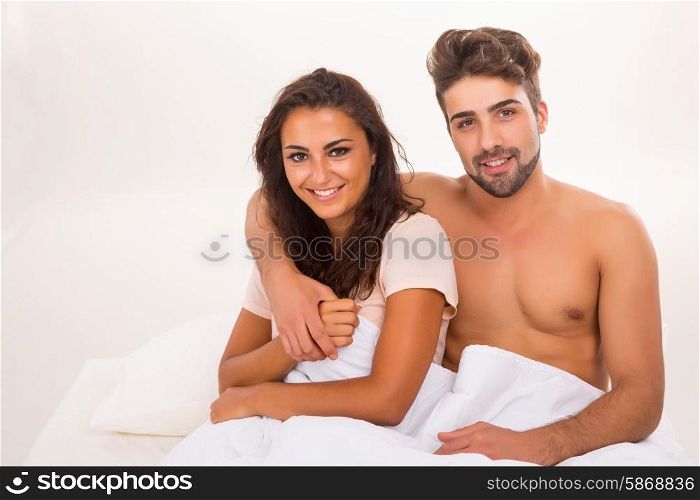 A beautiful young passionate couple in bed