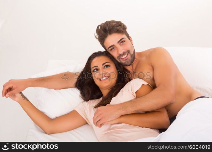 A beautiful young passionate couple in bed