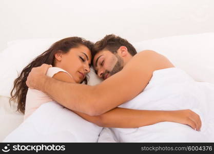 A beautiful young passionate couple in bed