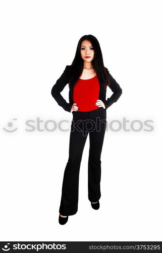 A beautiful young slim Asian business woman in a black jacked anddress pants with long black hair standing for white background.