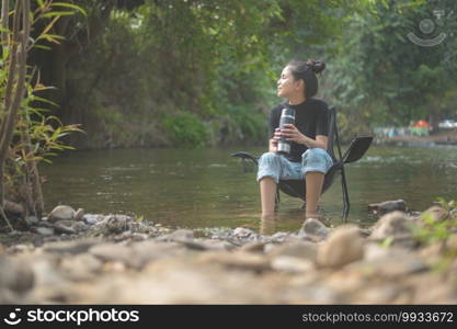 A beautiful young traveler woman is enjoying with nature drinking coffee in the morning over lake, relaxation , c&ing holiday and travel concept . . Beautiful young traveler woman is enjoying with nature drinking coffee in the morning over lake, relaxation , c&ing holiday and travel concept . 