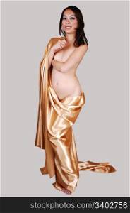 A beautiful young woman from the front, covering her breasts with herarm and covert in gold satin, for light gray background.