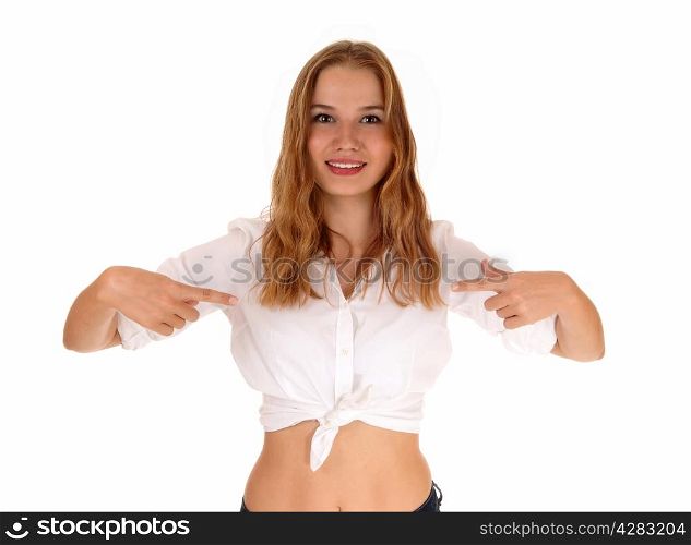 A beautiful young woman in a white blouse pointing with her fingers to herself, standing isolated for white background.