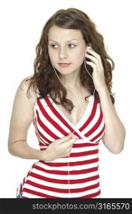 A beautiful young woman in red and white listens to music on earphones