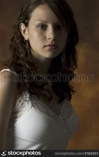 A beautiful young woman is lit from the side