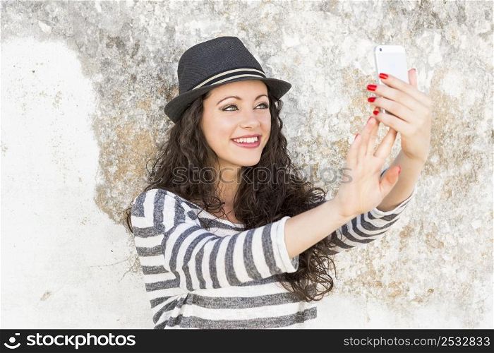 A beautiful young woman making a selfie with her cellphone