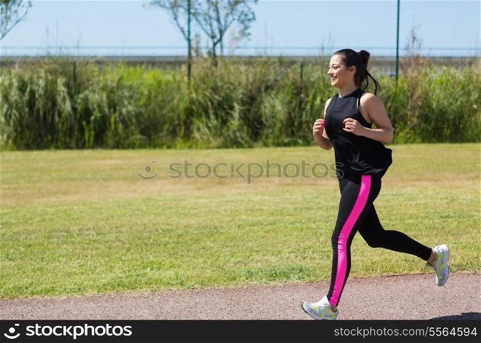 A beautiful young woman making some exercise at the park - fitness concept