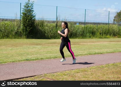 A beautiful young woman making some exercise at the park - fitness concept