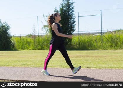 A beautiful young woman making some exercise at the park - fitness concept