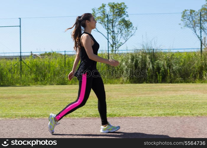 A beautiful young woman making some exercise at the park - fitness concept