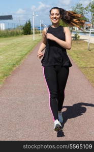 A beautiful young woman making some exercise at the park - fitness concept