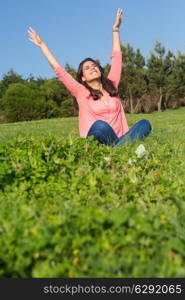 A beautiful young woman relaxing at the city park