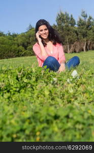 A beautiful young woman relaxing at the city park