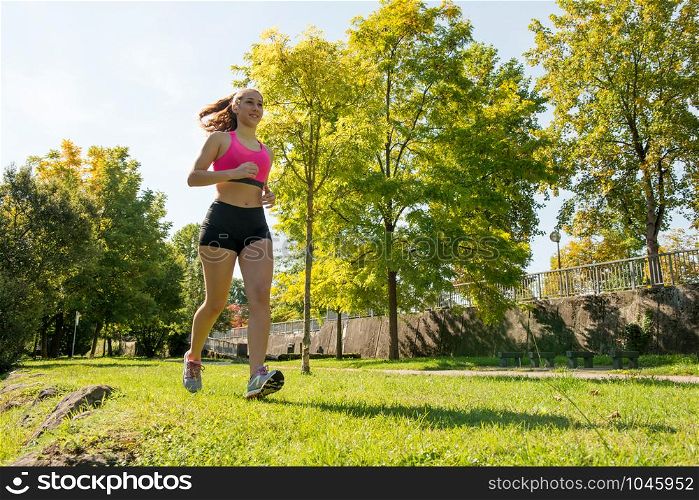 a beautiful young woman running in nature