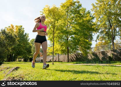 a beautiful young woman running in nature