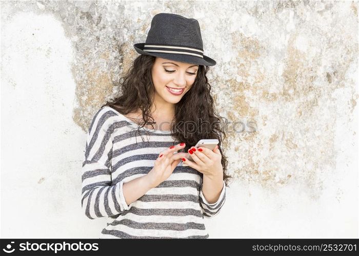 A beautiful young woman sending a text message