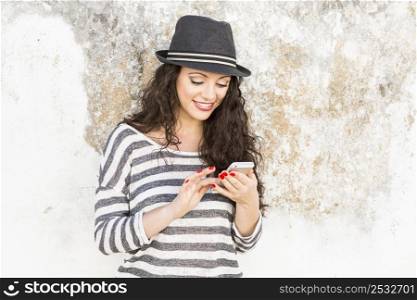 A beautiful young woman sending a text message