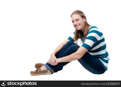 A beautiful young woman sitting on the floor