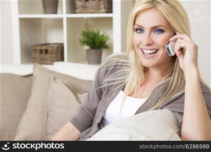 A beautiful young woman talking on her cell phone at home