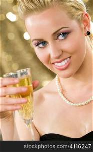 A beautiful young woman with bright blue eyes enjoying a glass of champagne.