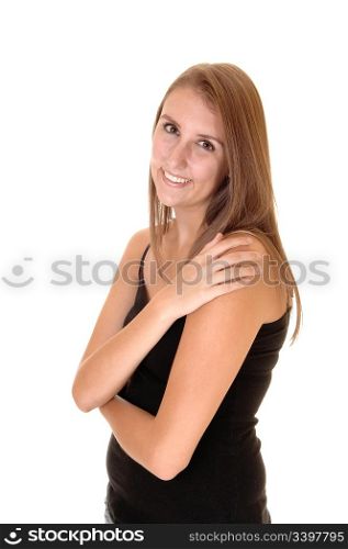 A beautiful young woman with brunette hair in a black dressStanding smiling in the studio, for white background.