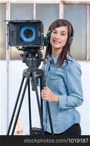 a beautiful young woman with DSLR video camera