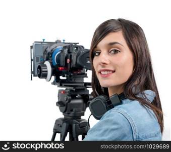 a beautiful young woman with DSLR video camera and headphones