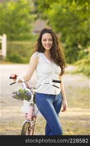 A beautiful young woman with her bicycle