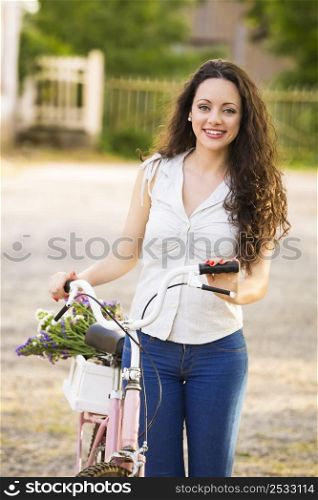 A beautiful young woman with her bicycle