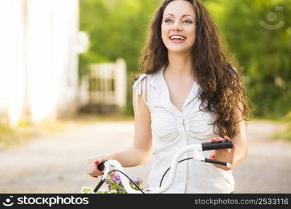 A beautiful young woman with her bicycle