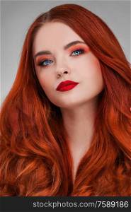 A beauty shot of a young woman with red hair and beauty make-up. Woman with red hair