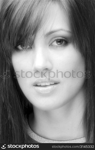 A beauty shot of an attractive woman with straight hair and beautiful youthful skin.
