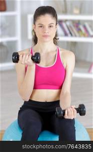 a beautyful sporty girl with dumbbell