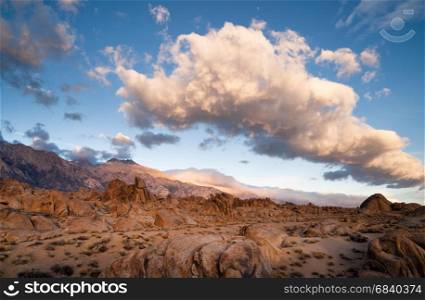 A big beautiful white cloud mass passes over the Alabama Hills in California