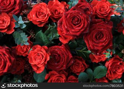 A big floral arrangement with red roses